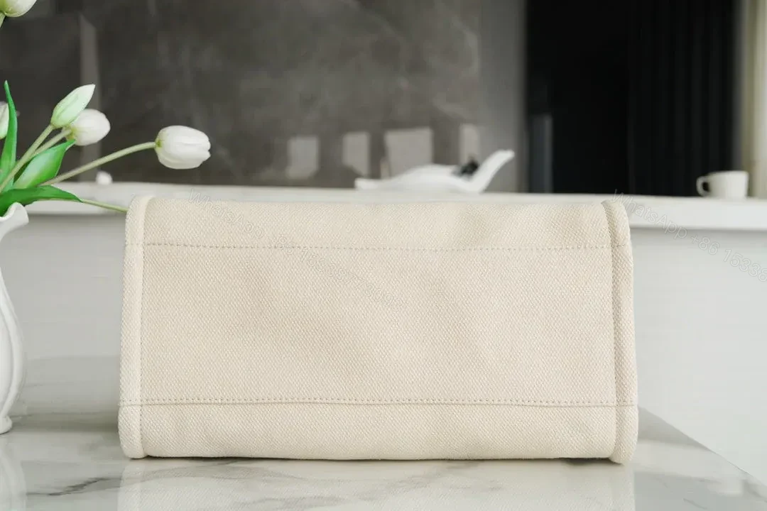 View 7 of CHANEL TOTE BAG 39 ATTACHED PEARL LOGO IN BEIGE CANVAS GOLD HARDWARE
