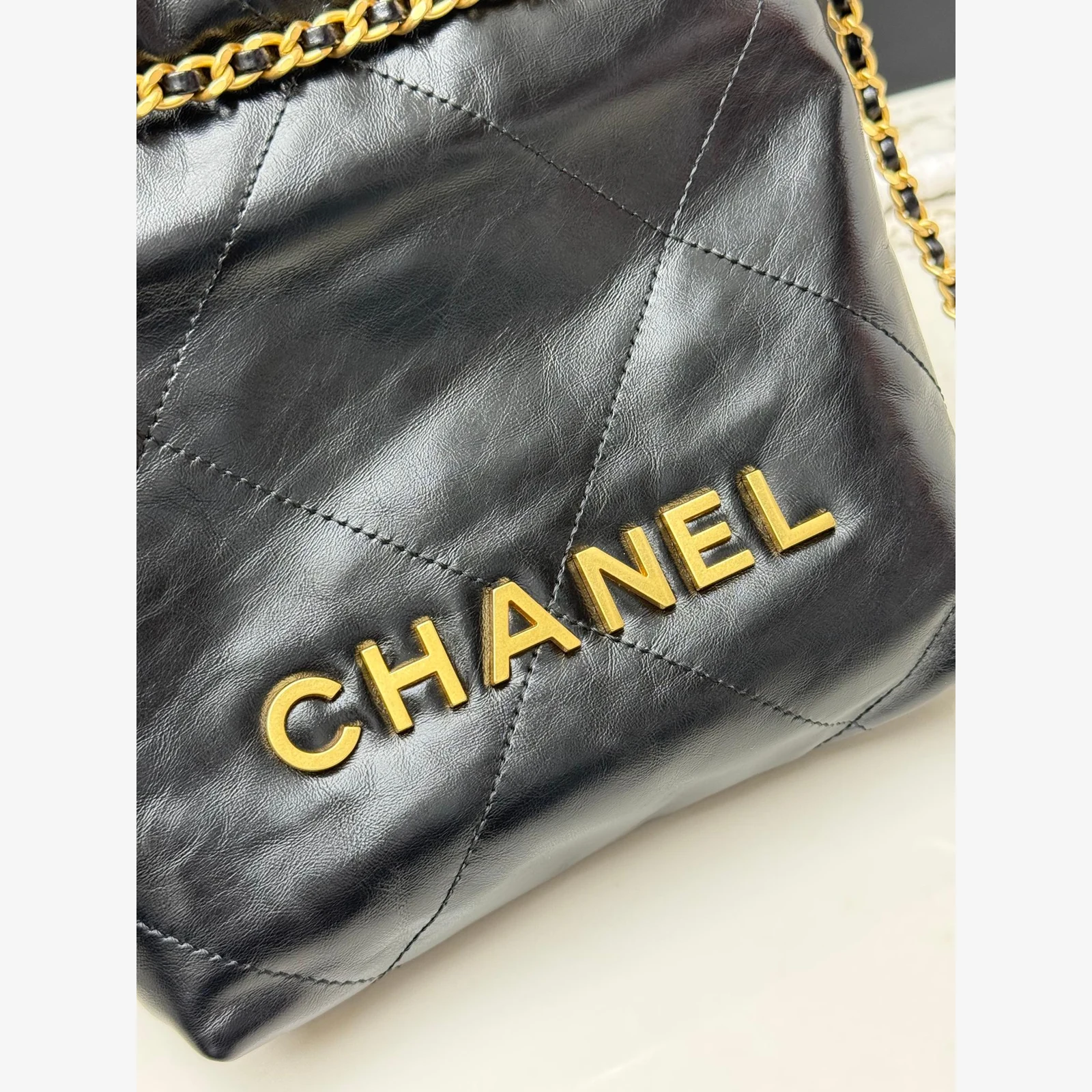 Chanel 22 Mini Handbag · Black Shiny Calfskin Black · Shiny Calfskin · Gold-Tone Metal